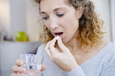 Woman taking a menopause supplement