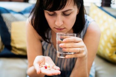 Woman taking the pill and antibiotics together