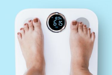 Weigh yourself on a set of scales and take a photo of your feet clearing showing your weight