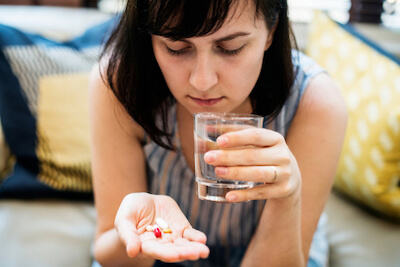 Woman taking the pill and antibiotics together